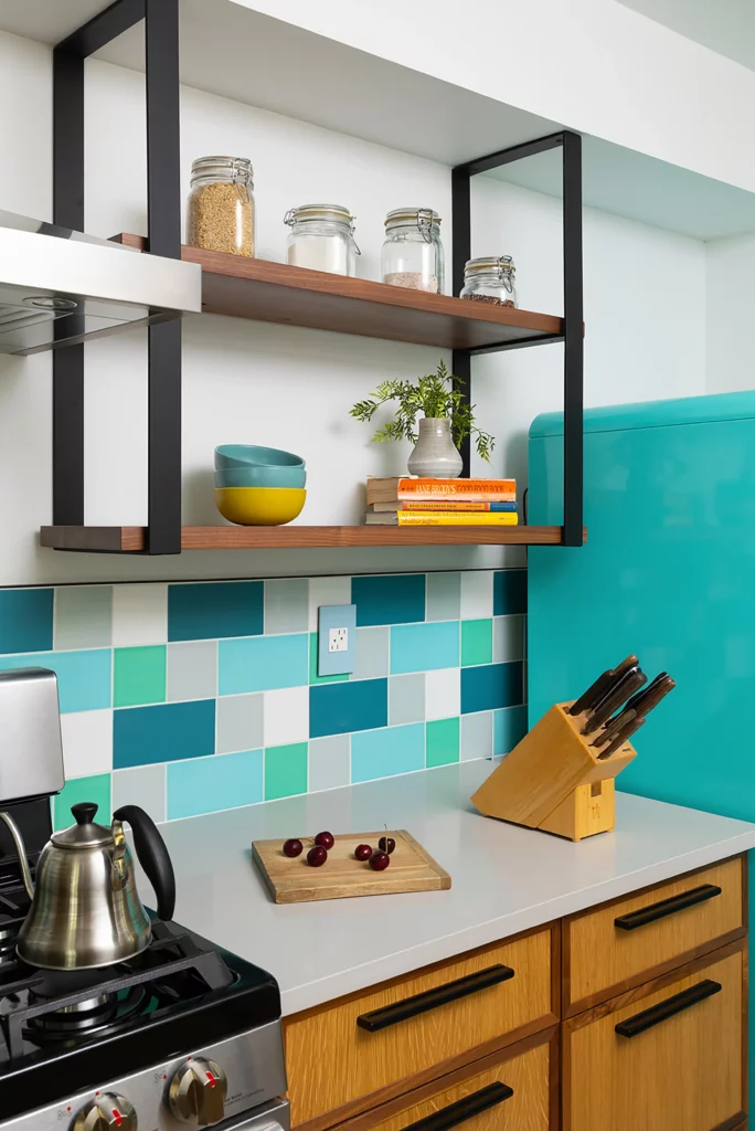 Kitchen remodel showing with open shelving and graphic blue backsplash