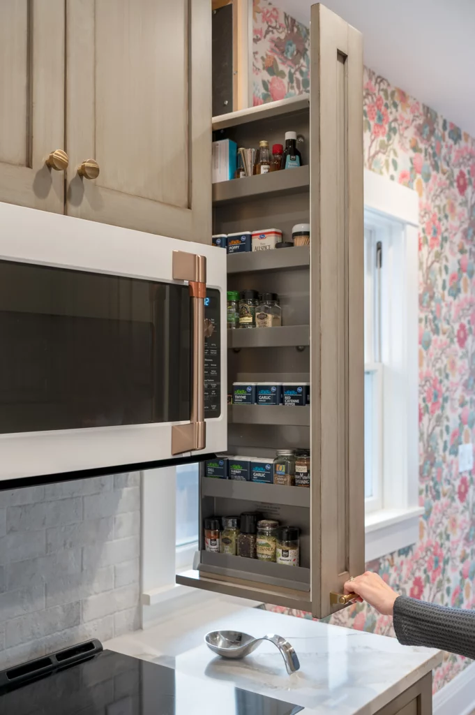 Sliding cabinetry with floral wallpaper accent on wall